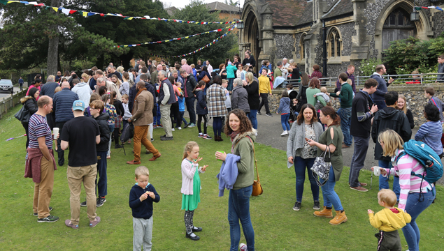 photo of church community congregated on the front lawn chatting and drinking coffee