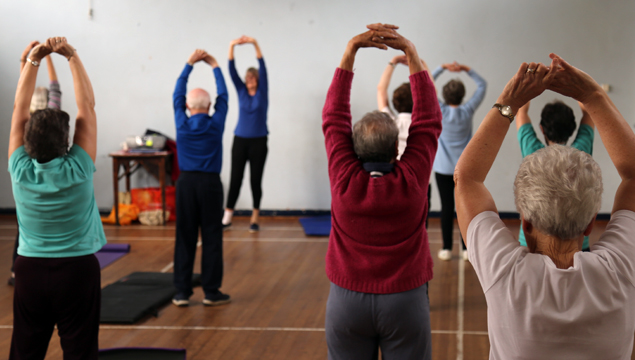 photo of people stretching their arms during friday fitness class