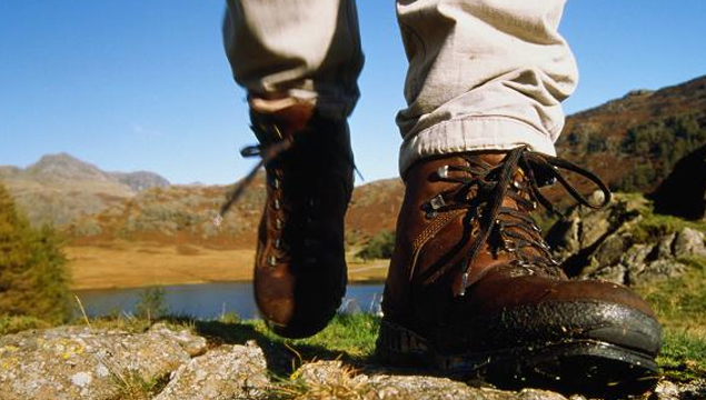 photo of feet in walking boots strolling through the countryside